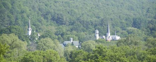 aerial of Vermont town through woods